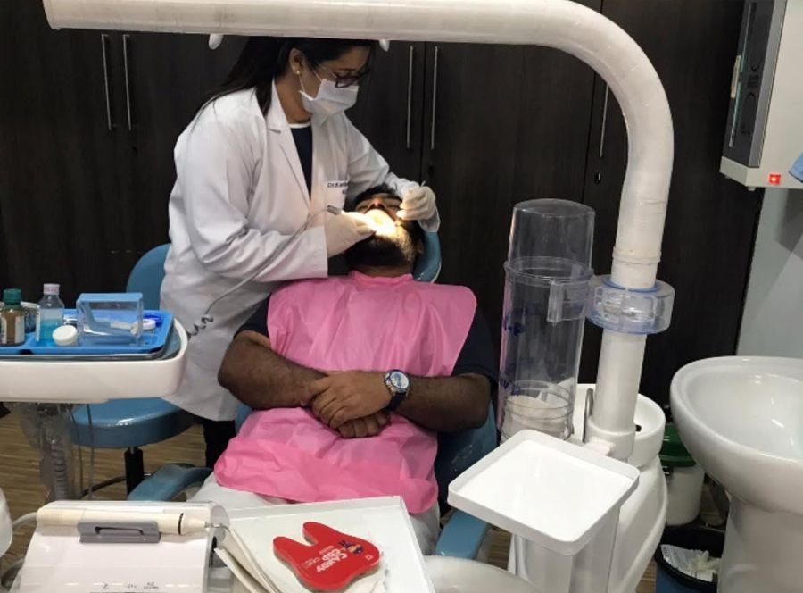 Dentist performing a dental procedure on a patient at RNC Dental Clinic Gurgaon